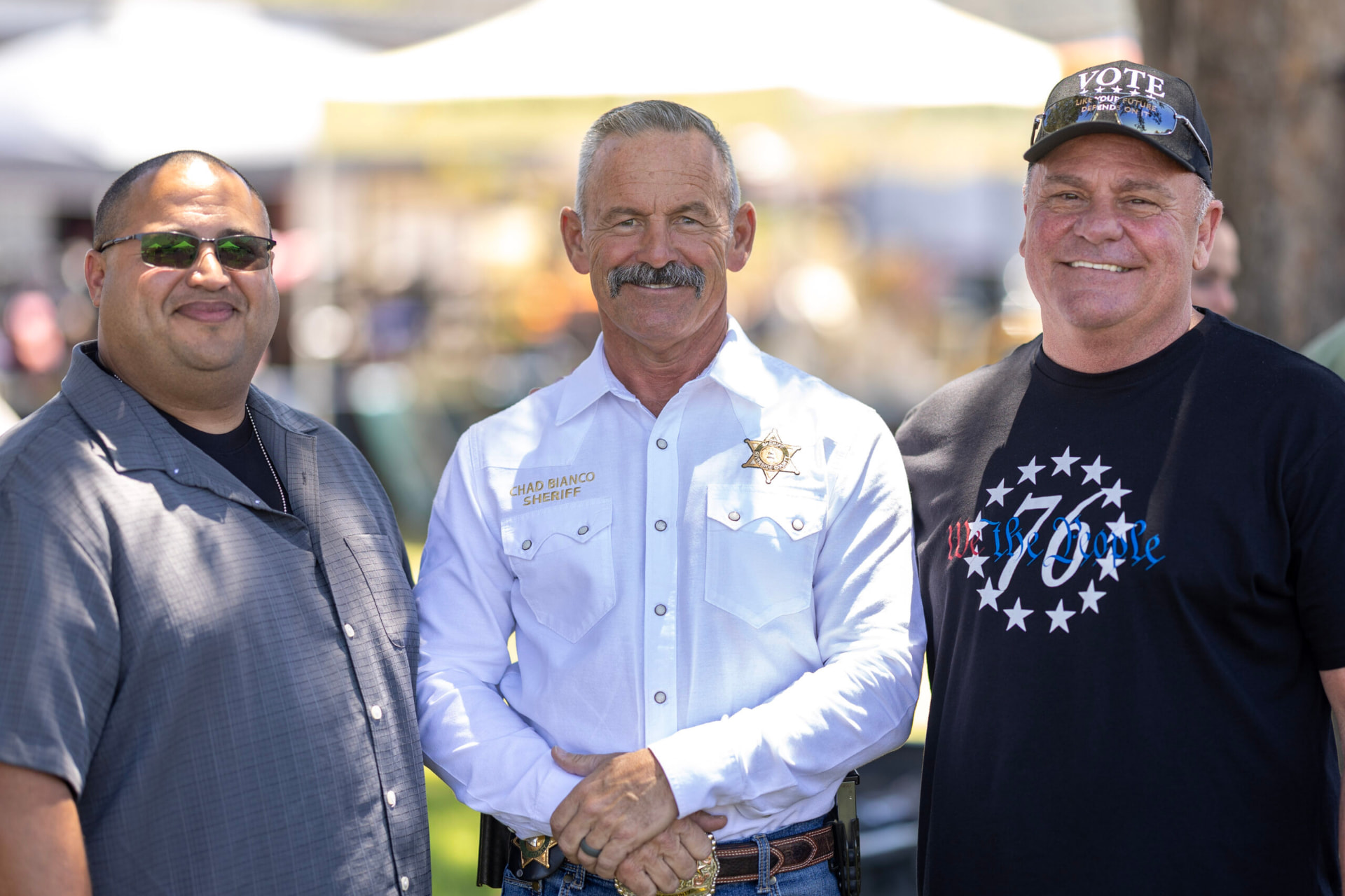 Chad Bianco with supporters at an outdoor event