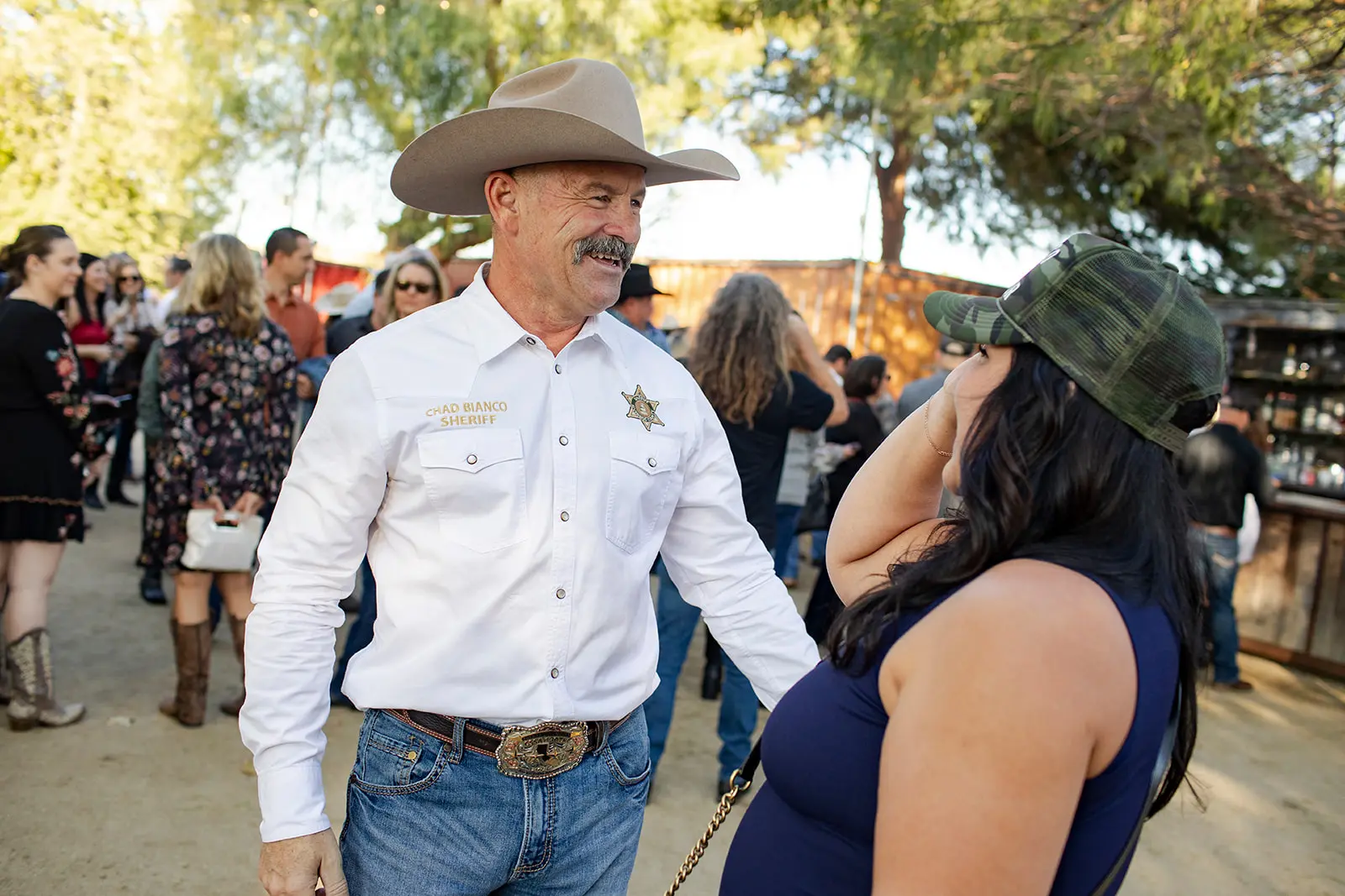 Sheriff Chad Bianco talking with a resident at an outdoor community event