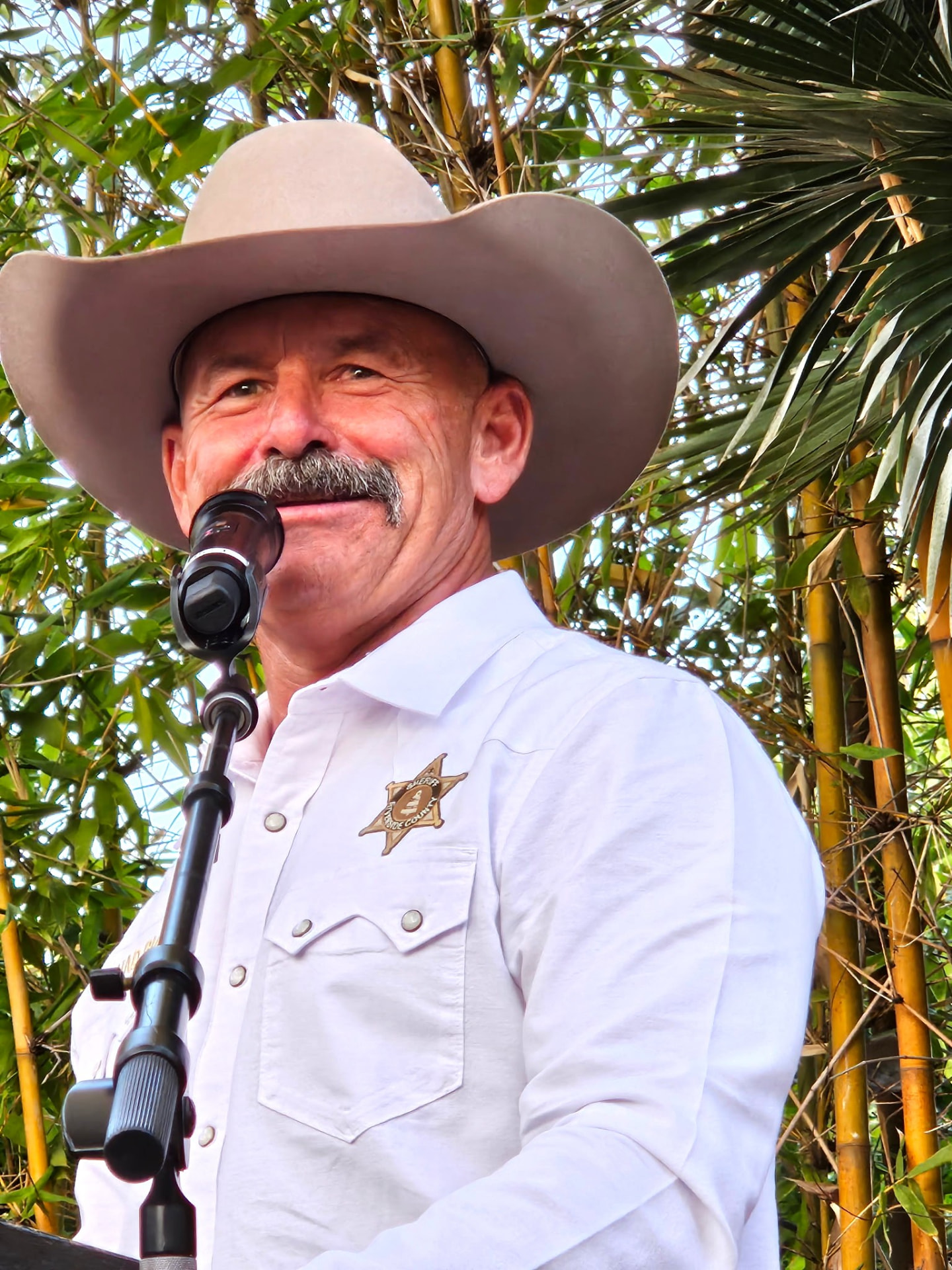 Sheriff Chad Bianco speaking at an outdoor campaign event